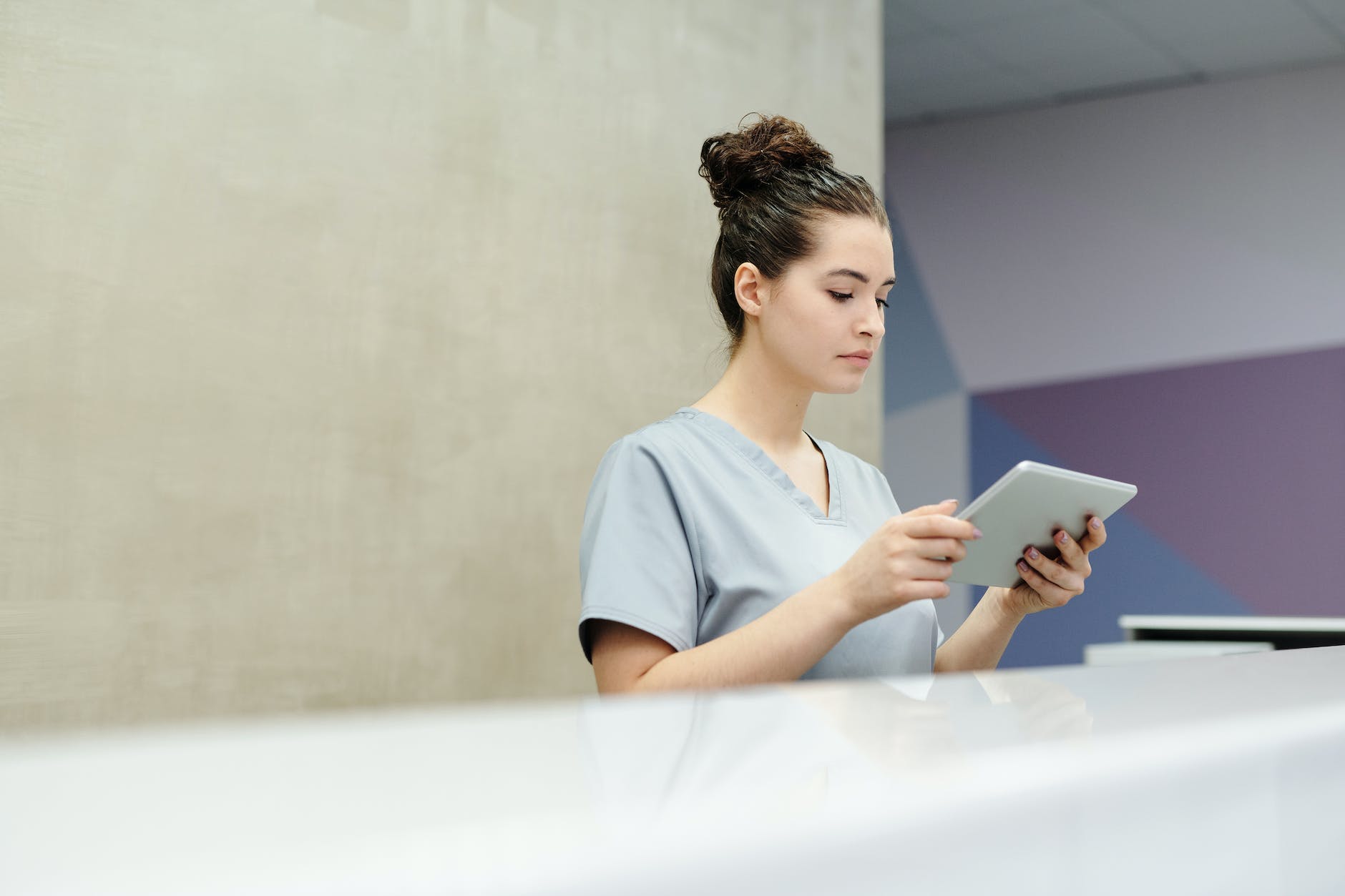 a receptionist looking at a tablet