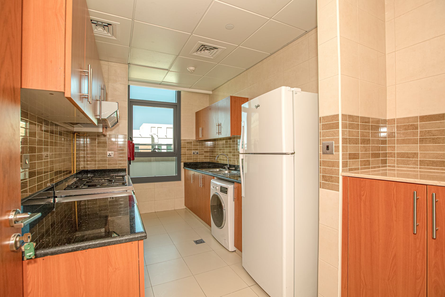 white top mount refrigerator beside white top mount dishwasher